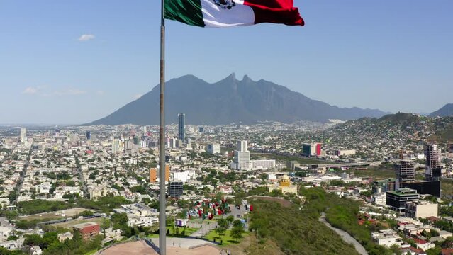 Aerial Ascending Shot Of Tall Flag At Mirador Del Obispado On Hill In City Near Mountains Against Sky - Monterrey, Mexico
