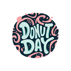 A donut with the word "donut day" written on it. The donut is yellow and has a glaze on it