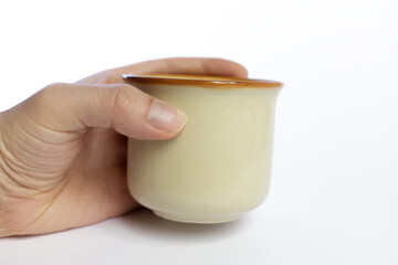 a hand one ceramic empty coffee mug isolated on white background 