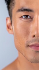 Fototapeta premium Close-up of a Young Asian Man with Clear Skin and Intense Gaze