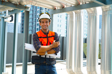 Foreman engineer wearing reflective jacket, engineering helmet, holding walkie-talkie and...