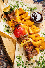 kebab with baked potato and sauce