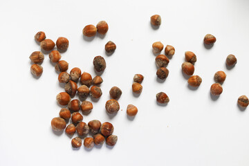 stack of hazelnuts on white background