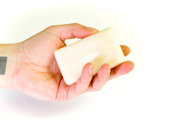 hand holding a  soap bar , isolated white background