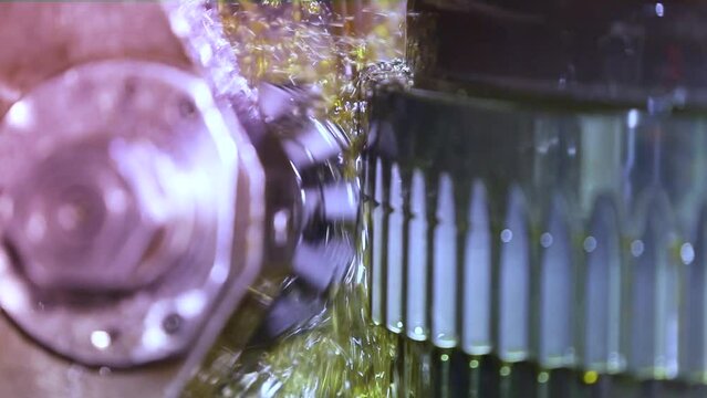Close up of CNC grinding milling machine. CNC turning center. CNC machining high precision turning throwing coolant liquid on metal component during shaping forming process using machining center