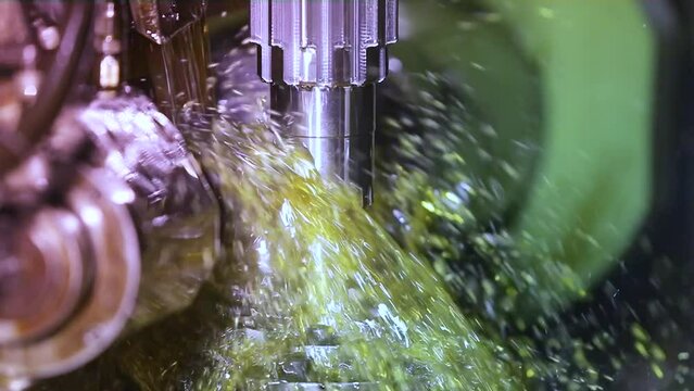 CNC grinding milling machine. CNC turning center. CNC machining high precision turning throwing coolant liquid on metal component during shaping forming process using machining center