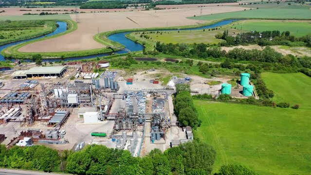 Aerial footage of the village of Knottingley in Wakefield in the UK, showing the waste removal scap metal site along side the Leeds and Liverpool canal on a bright sunny summers day