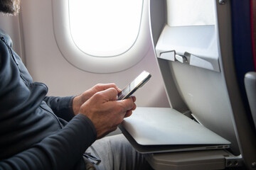 man working on a laptop during flight