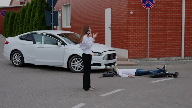 Dangerous accident involving car and scooter woman swiftly calls for emergency assistance to aid injured party. Video highlights dangers of road collisions critical importance of medical attention.