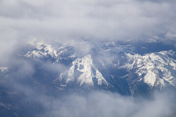 aerial view of snow covered mountain peaks in the Alps