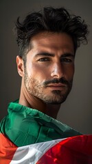 Obraz premium A portrait of a handsome Italian man highlighted by the vibrant colors of the Italian flag. Naturally beautiful Italian man with a feeling of national pride.