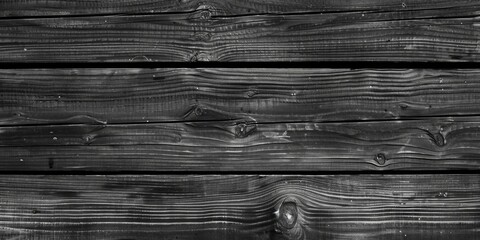 A black and white photo of a wooden wall. Suitable for backgrounds and textures