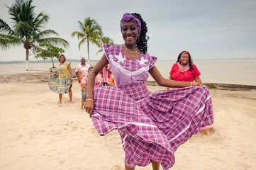 Portrait of a beautiful girl dancing on the beach, wearing a lilac dress.