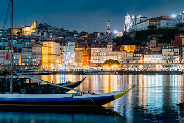 Porto, Portugal old town on the Douro River with traditional rabelo boats at night. With wine barrels from the port on the Douro River, Ribeira I in the background, Porto, Portugal. - 788576465