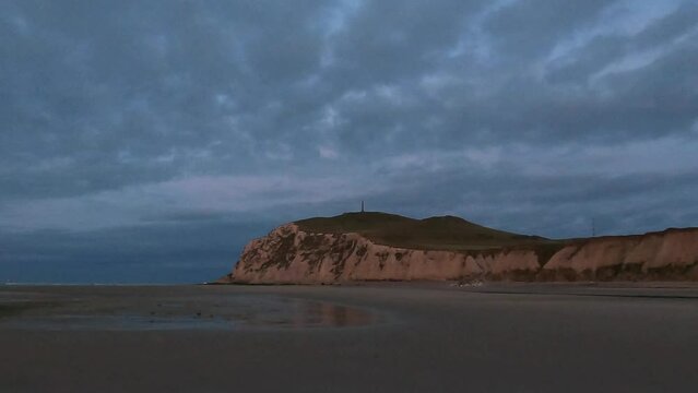 This captivating footage unfolds at the majestic Cap Blanc Nez on Frances northern coast, where the chalk cliffs meet the gentle tides. As day turns to dusk, the fading sunlight bathes the landscape