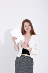 woman with a book, magazine and laptop on a white background. student. business. mockup