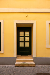 A door with steps on the facade of an apartment building