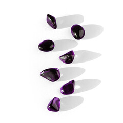 Semi-transparent violet stones for spiritual healing and meditation or yoga for well-being, with transparent background and shadow with caustics