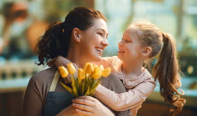 daughter and mom with flowers - obrazy, fototapety, plakaty