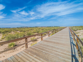 Wooden bridge over sand dunes near the beach, Huelva, Spain. 08-08-2023