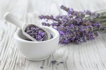 Lavender flowers in a white bowl with a wooden spoon. Ideal for aromatherapy or natural skincare concepts