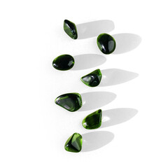 Semi-transparent green stones for spiritual healing and meditation or yoga for well-being, with transparent background and shadow with caustics