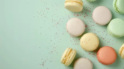 Foto op Canvas A bunch of macarons on a table with confetti sprinkles. Perfect for bakery or celebration concepts © Fotograf