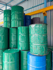Many oil barrels are stored in the warehouse.