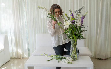 Charming Young Woman Arranging Flowers