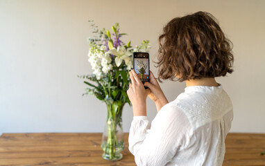 Florist girl takes a photo with phone