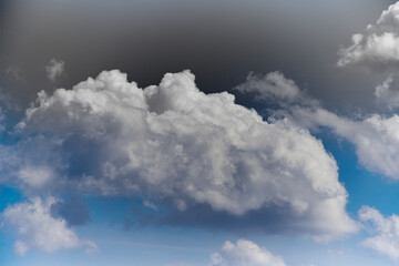 White clouds in the blue sky, close-up of clouds in the blue sky, light on the clouds in the sky