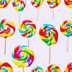 Several lollipops of different colors and flavors on a pink background.