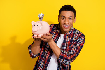 Photo of nice cheerful rich man wear stylish checkered clothes hold piggy bank money savings...