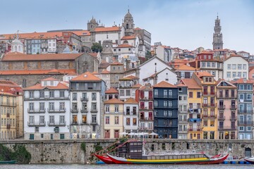 Porto, Skyline view of the old town of Portugal on the Douro river. Travel and monuments of Portugal. Old historic houses of Porto. Rows of colorful buildings in traditional architectural style. - 788629211