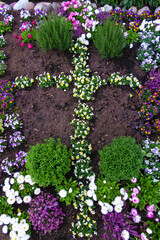 Spring Easter flowerbed  with a cross of flowers