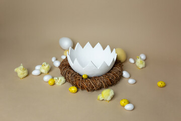 background texture large white shell on a beige background with small eggs and chicks. Easter photo zone for children. empty space for text. plaster shell