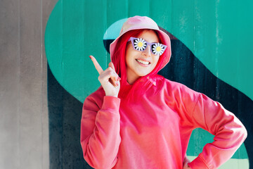Wow, excited emotional smiling woman in sunglasses with flowers stickers. Playful woman with pink hair,bucket hat and magenta sweatshirt. Vanilla Girl. Kawaii vibes. Candy colors design. Flower mood