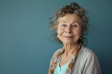 An elderly woman with curly hair is smiling for the camera