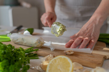 Wrapping up herb butter into wax paper