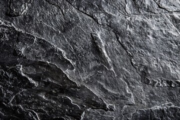 Dark grey black slate background or texture. Black stone surface with cracks.