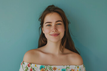 A woman wearing a floral off the shoulder top smiles for the camera