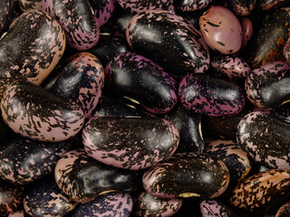 Heap of black-pink marbled beans, whole beans seeds, natural texture, background.