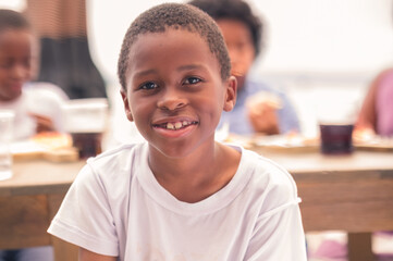 Portrait of an African American boy looking at the camera. Garifuna boy having a good time with his...