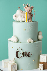 Two tier birthday cake for a little kid with turquoise chocolate frosting. Birthday cake for a one...
