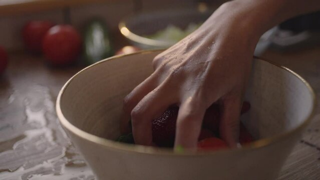 Eating strawberries, washing and preparing vegetables in the kitchen