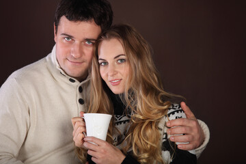 Portrait of a happy young couple with cup