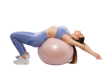 Slim, bodybuilder girl in a lilac tracksuit, sitting on a mat with a Pilates ball,  cardio workout. Sports concept, fat burning and healthy lifestyle.