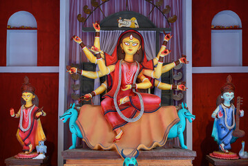Obraz na płótnie Canvas Idol of Goddess Devi Durga at a decorated puja pandal in Kolkata, West Bengal, India. Durga Puja is a famous and major religious festival of Hinduism that is celebrated throughout the world.