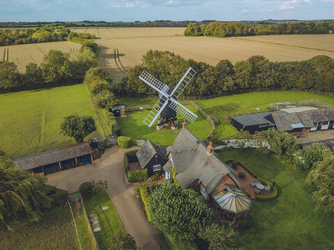 Aerial view of Bourn Windmill amidst picturesque countryside, Caxton, England.