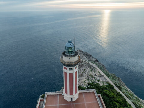 Aerial view of beautiful lighthouse overlooking Mediterranean sea, Capri Island, Italy.